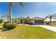 One-story house with palm trees, screened entry and garage at 16446 Belo Ct, Punta Gorda, FL 33955