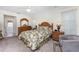 Bright bedroom with floral bedding, wooden furniture, and ceiling fan at 16446 Belo Ct, Punta Gorda, FL 33955