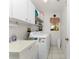 Laundry room with washer, dryer, utility sink and shelving at 16446 Belo Ct, Punta Gorda, FL 33955
