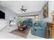 Spacious Gathering room featuring teal couches, a coffee table, and access to a pool at 16446 Belo Ct, Punta Gorda, FL 33955