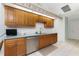 Modern kitchen with stainless steel appliances and wood cabinetry at 16446 Belo Ct, Punta Gorda, FL 33955