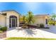 Well-maintained house exterior featuring a welcoming entryway and landscaping at 16446 Belo Ct, Punta Gorda, FL 33955