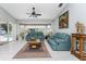 Spacious Gathering room featuring teal couches, a coffee table, and access to a pool at 16446 Belo Ct, Punta Gorda, FL 33955