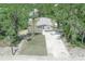 Aerial view of a single-story home with a driveway and surrounding trees at 8191 Strasse Blvd, Punta Gorda, FL 33982