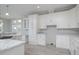 Modern kitchen with white cabinets and a large island at 8191 Strasse Blvd, Punta Gorda, FL 33982