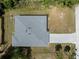 Overhead aerial view of home's roof and driveway surrounded by grassy yard at 2049 Delta St, Port Charlotte, FL 33952