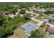 Aerial view of the home situated among lush trees in a residential neighborhood at 2049 Delta St, Port Charlotte, FL 33952