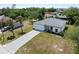 Aerial view of home featuring a long driveway and a two-car garage at 2049 Delta St, Port Charlotte, FL 33952