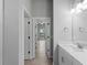Hallway view of the bathroom with a white vanity and tile flooring at 2049 Delta St, Port Charlotte, FL 33952