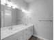 Bright bathroom featuring a double sink vanity and a large mirror at 2049 Delta St, Port Charlotte, FL 33952