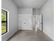 Bedroom with closet and neutral gray walls and gray wood-look tiling. A window provides natural light at 2049 Delta St, Port Charlotte, FL 33952