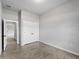 Bedroom with closet and neutral gray walls and gray wood-look tiling. A window provides natural light at 2049 Delta St, Port Charlotte, FL 33952
