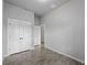 Bedroom with closet and neutral gray walls and gray wood-look tiling. A window provides natural light at 2049 Delta St, Port Charlotte, FL 33952