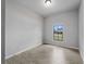 Bedroom with neutral gray walls and gray wood-look tiling. A window provides natural light at 2049 Delta St, Port Charlotte, FL 33952