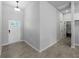 Bright, tiled foyer featuring front door, coat closet, and entry to other rooms at 2049 Delta St, Port Charlotte, FL 33952