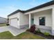 Beautiful single story home with an attached garage, well manicured landscaping, and a light blue front door at 2049 Delta St, Port Charlotte, FL 33952