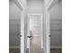 Hallway with open doors leading to bathroom and closets with wire shelving at 2049 Delta St, Port Charlotte, FL 33952