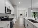 Modern kitchen with stainless steel appliances, ample counter space, and white cabinetry at 2049 Delta St, Port Charlotte, FL 33952