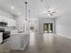 Open floor plan showing living room and kitchen with stainless appliances and tile floors at 2049 Delta St, Port Charlotte, FL 33952