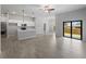 Spacious open floor plan featuring wood-look tile, large sliding glass doors, and open kitchen at 2049 Delta St, Port Charlotte, FL 33952