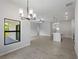 Open-concept living space with modern kitchen and dining area and neutral walls at 2049 Delta St, Port Charlotte, FL 33952