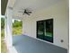 Covered patio with a ceiling fan and sliding glass doors to the home's interior at 2049 Delta St, Port Charlotte, FL 33952