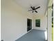View of the patio showing ceiling fan, sliding glass door, and window at 2049 Delta St, Port Charlotte, FL 33952