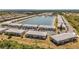 Aerial view of a community with lake, featuring multiple residential buildings and ample parking at 3310 Loveland Blvd # 1502, Punta Gorda, FL 33980