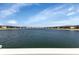 Serene lake view with community buildings in background at 3310 Loveland Blvd # 1502, Punta Gorda, FL 33980
