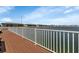 Brown wood deck with white railings and lake view at 3310 Loveland Blvd # 1502, Punta Gorda, FL 33980