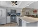 Modern kitchen with stainless steel appliances and breakfast bar at 3310 Loveland Blvd # 1502, Punta Gorda, FL 33980