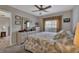 King-size bed, dresser, ceiling fan, and window with curtains in a spacious bedroom at 3310 Loveland Blvd # 1502, Punta Gorda, FL 33980