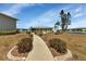 Paved pathway meanders through landscaped grounds towards community building at 3310 Loveland Blvd # 1502, Punta Gorda, FL 33980