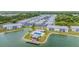 Aerial view of a waterfront community featuring a pool, dock, and many residential buildings at 3310 Loveland Blvd # 1502, Punta Gorda, FL 33980