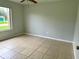 Bright bedroom featuring tile flooring and ceiling fan at 1160 Belkton Ave, Port Charlotte, FL 33948
