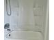 White bathtub and shower with built-in shelves at 1160 Belkton Ave, Port Charlotte, FL 33948