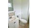 Clean bathroom with vanity, toilet, and tiled accents at 1160 Belkton Ave, Port Charlotte, FL 33948