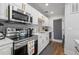 Updated kitchen with stainless steel appliances, white cabinets and stainless steel hardware at 1500 Park Beach Cir # 3C, Punta Gorda, FL 33950