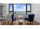 Cozy seating area features water views, wood flooring, and two blue chairs at 1500 Park Beach Cir # 3C, Punta Gorda, FL 33950