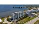 Aerial view of waterfront condo building with parking and surrounding landscape at 1500 Park Beach Cir # 3C, Punta Gorda, FL 33950