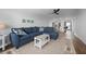 Open living room with sectional sofa, hardwood floors, and kitchen views at 1500 Park Beach Cir # 3C, Punta Gorda, FL 33950
