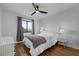 Bright bedroom with wood floors, a ceiling fan, and window views at 1500 Park Beach Cir # 3C, Punta Gorda, FL 33950