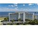 Aerial view of waterfront condo building with parking and landscaped grounds at 1500 Park Beach Cir # 3C, Punta Gorda, FL 33950