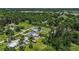 A fantastic aerial view shows the home with water in the distance, and a large outbuilding at 27437 Dutch Ave, Punta Gorda, FL 33982