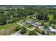 Scenic aerial perspective of this charming residence, enhanced by lush landscaping and a functional outbuilding at 27437 Dutch Ave, Punta Gorda, FL 33982