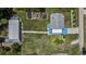 An aerial view shows the home with its long driveway, a spacious yard, and a large outbuilding at 27437 Dutch Ave, Punta Gorda, FL 33982