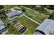 Aerial view featuring this home, its outbuilding, a long driveway, and spacious yard at 27437 Dutch Ave, Punta Gorda, FL 33982