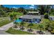 Gorgeous aerial shot highlighting the property with mature landscaping, an outbuilding, and well-manicured lawn at 27437 Dutch Ave, Punta Gorda, FL 33982