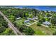 An aerial view shows a charming home on a lush, green lot near a body of water at 27437 Dutch Ave, Punta Gorda, FL 33982