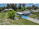 Expansive aerial view of the property featuring a well-maintained home with mature landscaping and outbuildings at 27437 Dutch Ave, Punta Gorda, FL 33982